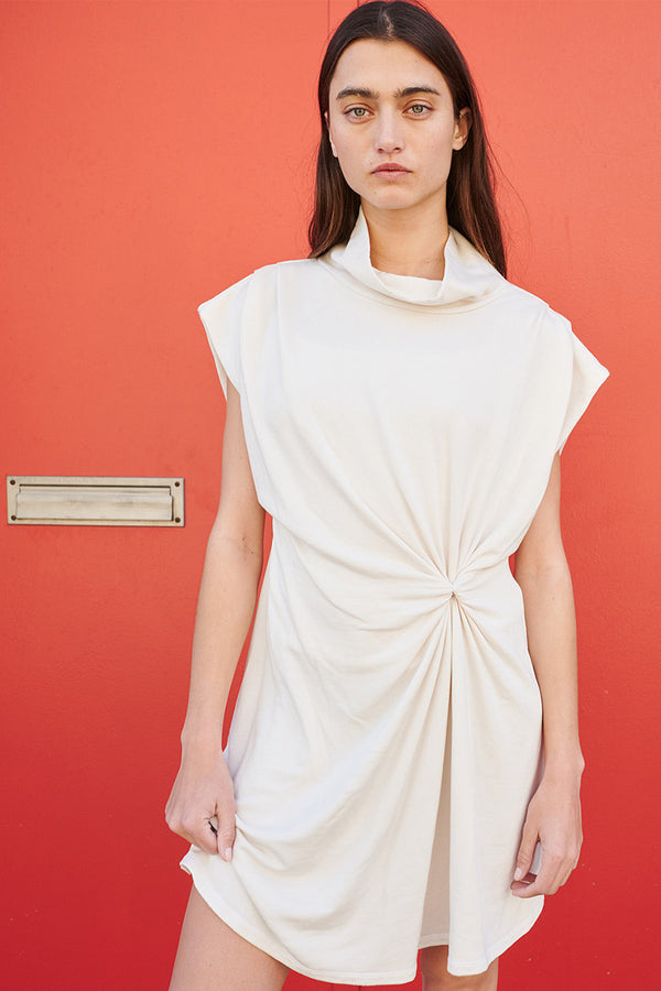 Stateside Softest Fleece Twist Midi Dress in Cream-model in front of red wall