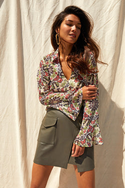 Krista Skirt in Bayleaf-model posing in front of back drop