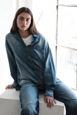 TBS EXCLUSIVE Stonewashed Chambray Oversized Shirt in Medium Wash-sitting down