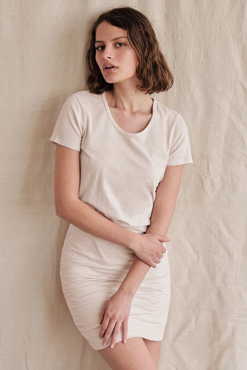 Sundry Short Sleeve Ruched Dress In Oatmilk- model has her arms crossed