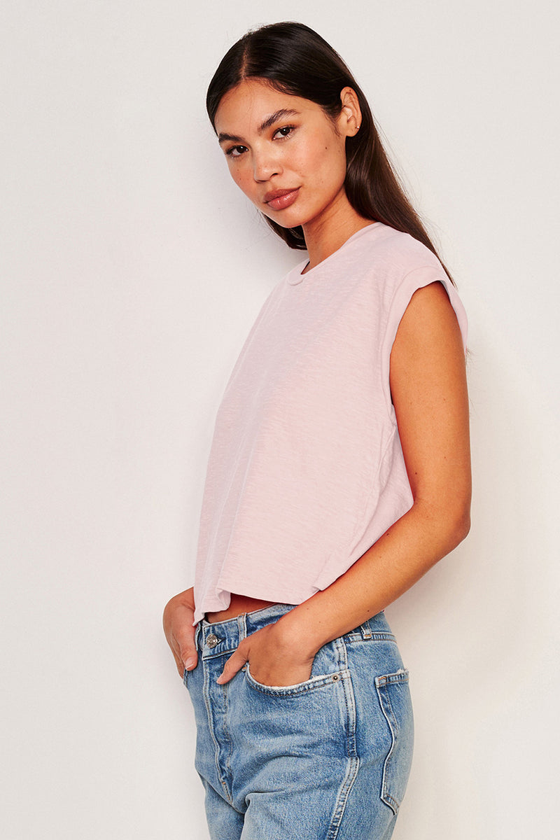 Sundry Muscle Tank in Flush Pink-side view with the models hands in her pocket 