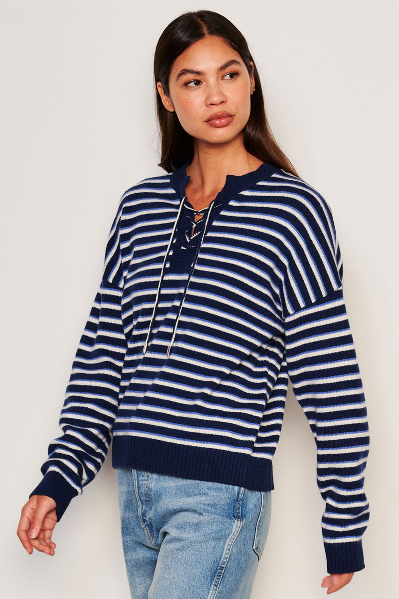 Sundry Stripes Lace Up Sweater in Oyster-model is looking away from camera and has her hands in a movement position