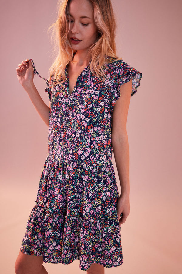 Sundry Mini Field Dress in Deep Navy-pink background model is looking down