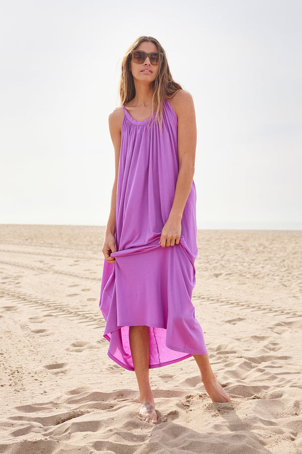 Sundry Long Cocoon Dress In Wild Orchid-model walking on the beach