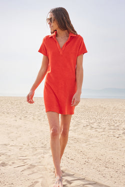 Sundry Mini Short Sleeve Polo Dress In Tango-model walking on the beach