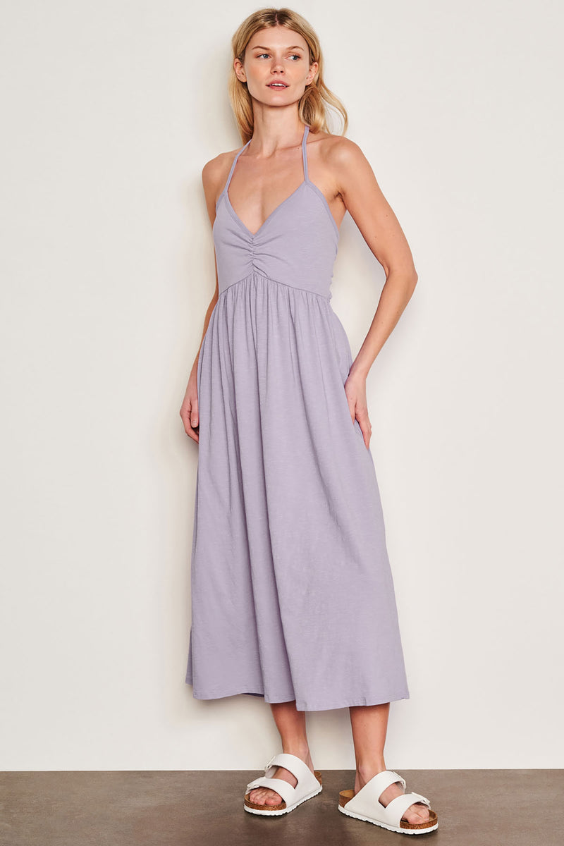 Sundry Tie Back Dress in Dark Lavender-model is looking over her shoulder 