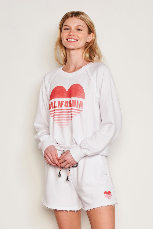 Sundry Cali Heart Raglan Sweatshirt in Optic White-side view model holding her hands together