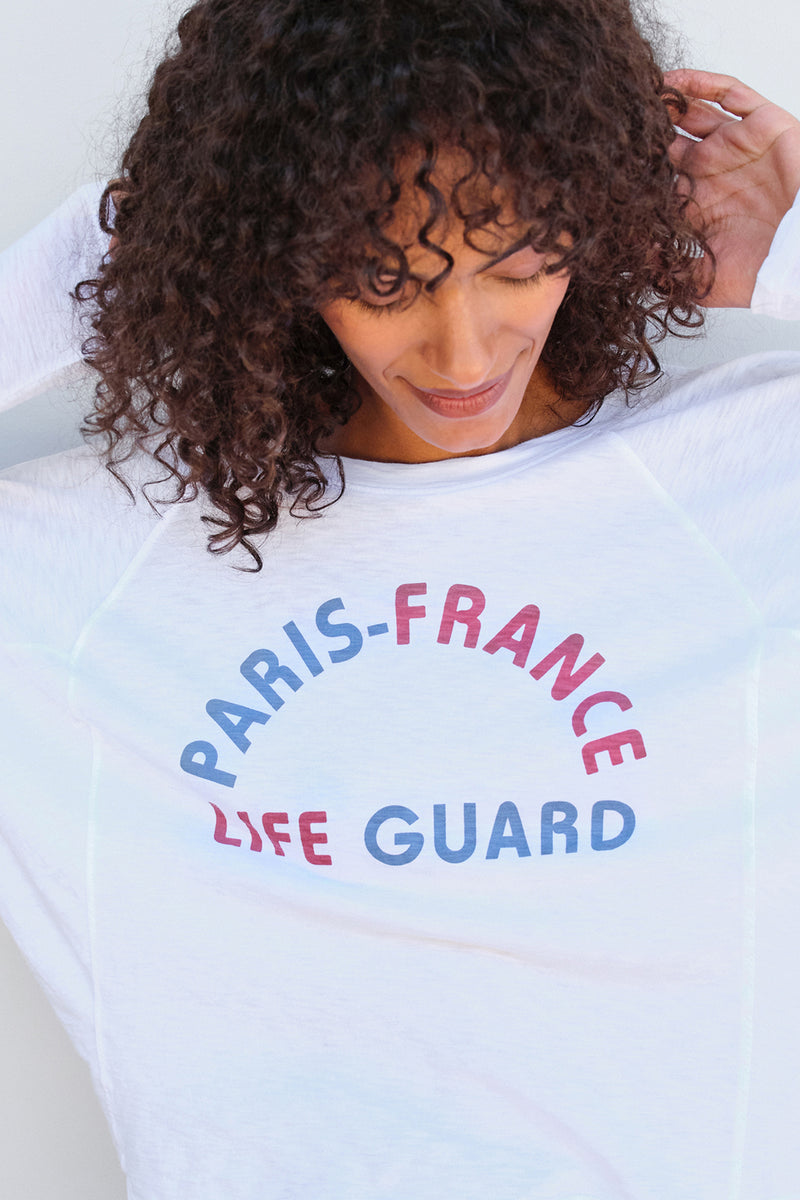 Sundry Life Guard Dolman Sleeve Tee in White-model looking down at graphic tee
