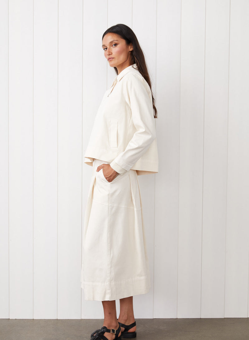 Cava Twill Peacoat in Cream - side full body image with the model with her hands in her pockets. 